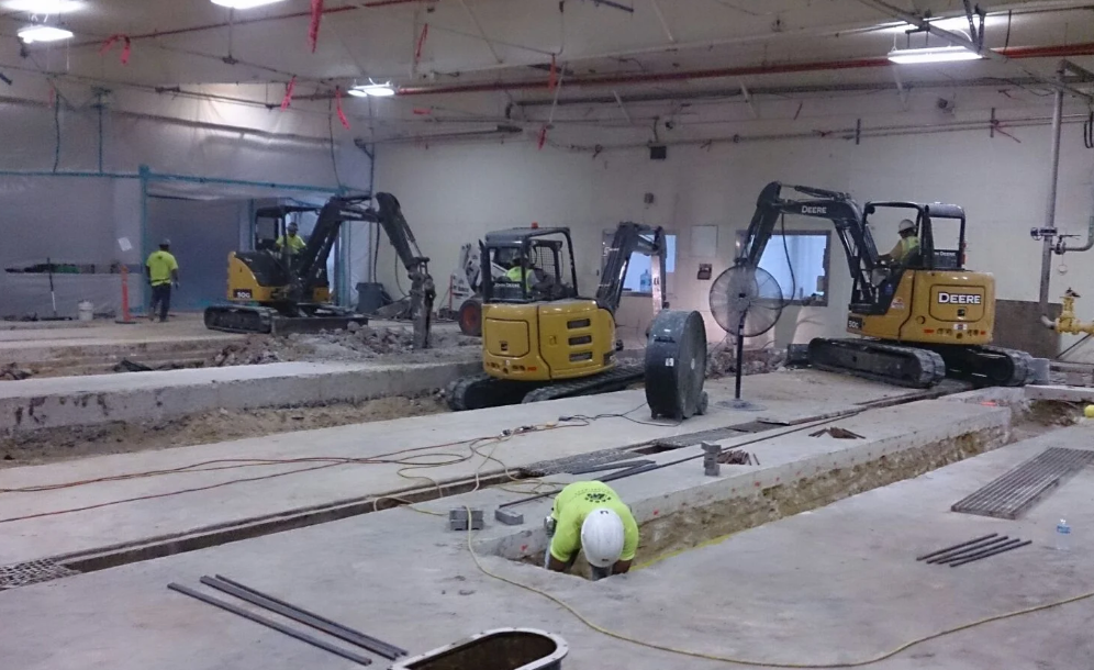 Excavator with hammer attachment performing concrete demolition (2)